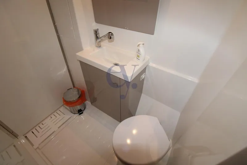  Yacht Photos Pics Bathroom interior of 2021 Fountaine Pajot Astrea 42 catamaran, featuring sink and toilet.