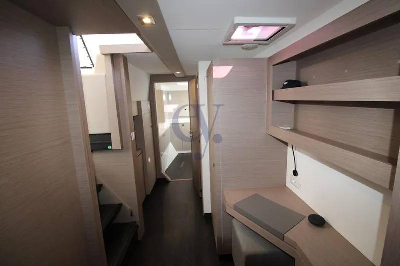  Yacht Photos Pics Interior of 2021 Fountaine Pajot Astrea 42 catamaran, featuring modern wood finishes and shelving.
