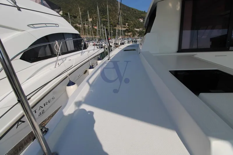  Yacht Photos Pics 2021 Fountaine Pajot Astrea 42 yacht docked in marina, showcasing sleek deck design.