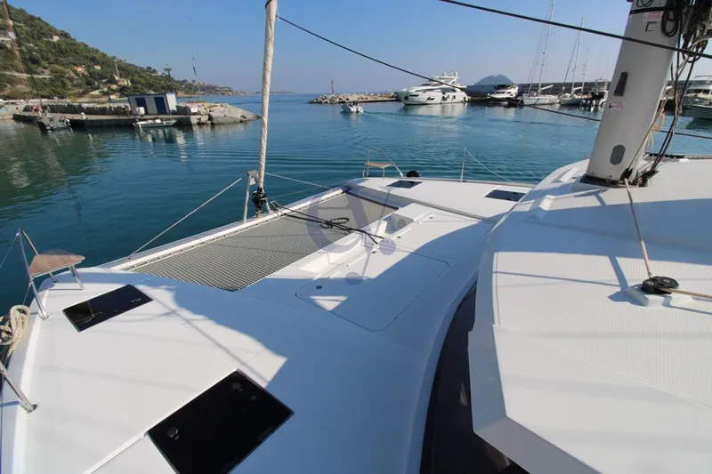  Yacht Photos Pics 2021 Fountaine Pajot Astrea 42 catamaran docked in a serene marina setting.