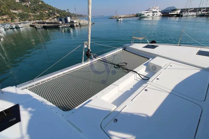 Yacht Photos Pics 2021 Fountaine Pajot Astrea 42 catamaran docked in a serene marina setting.