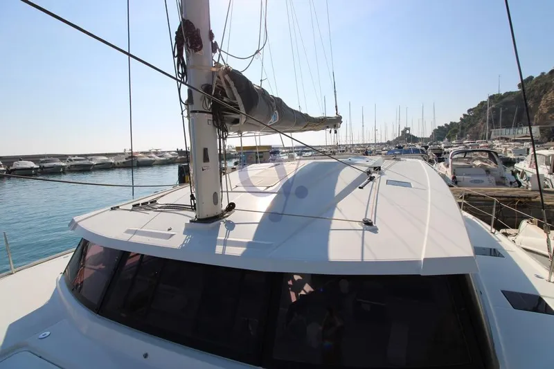  Yacht Photos Pics 2021 Fountaine Pajot Astrea 42 catamaran docked in a sunny marina.