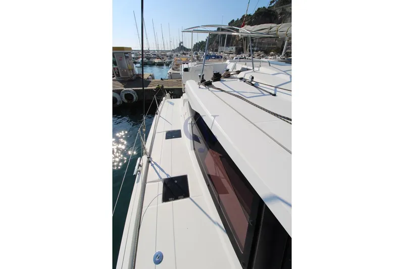  Yacht Photos Pics 2021 Fountaine Pajot Astrea 42 catamaran docked at marina, side deck view.