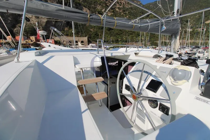  Yacht Photos Pics 2021 Fountaine Pajot Astrea 42 yacht helm with modern navigation equipment in a marina.