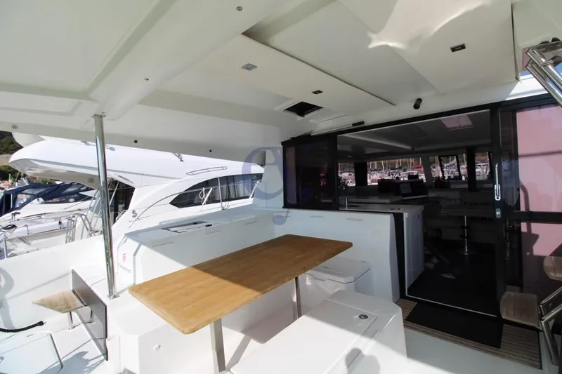  Yacht Photos Pics Spacious deck of 2021 Fountaine Pajot Astrea 42 catamaran with outdoor seating area.