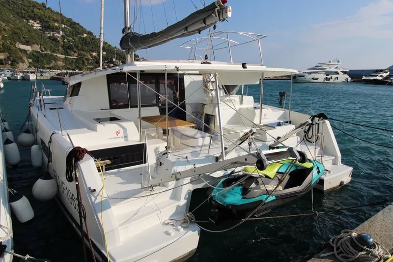  Yacht Photos Pics 2021 Fountaine Pajot Astrea 42 catamaran docked at marina with scenic background.
