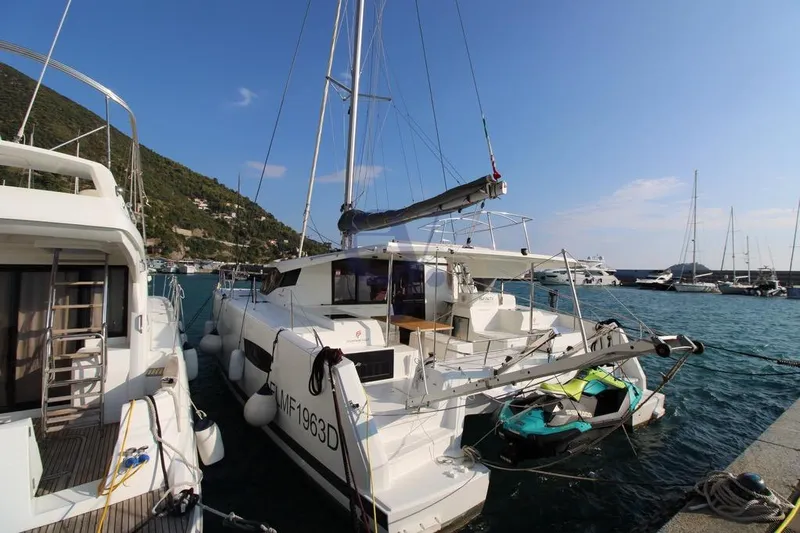  Yacht Photos Pics 2021 Fountaine Pajot Astrea 42 catamaran docked in a scenic marina.