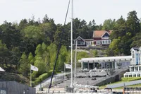 Sailboat "Scandinavian Cruiser Eagle" docked near scenic waterfront homes, 1989 model.
