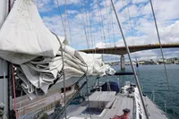 Sailboat deck view, Scandinavian Cruiser Eagle 1989, with sails and bridge in background.