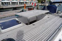Deck of 1989 Custom Scandinavian Cruiser Eagle with open hatch and marina background.