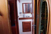 Interior of 1989 Scandinavian Cruiser Eagle, featuring wooden cabinetry and compact bathroom.