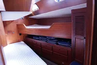 Cozy cabin interior of 1989 Scandinavian Cruiser Eagle with wooden bunk beds and storage.