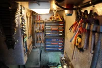 Workshop with organized tools and drawers inside a 1989 Custom Scandinavian Cruiser Eagle.