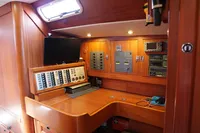 Navigation station in 1989 Scandinavian Cruiser Eagle, featuring control panels and wooden cabinetry.