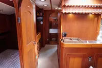 1989 Scandinavian Cruiser Eagle interior with wooden cabinetry and cozy sleeping quarters.