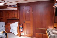 Interior of 1989 Scandinavian Cruiser Eagle with wooden paneling and cozy seating.