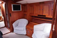 Interior of 1989 Scandinavian Cruiser Eagle with wooden cabinets and cozy seating.