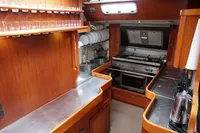 1989 Scandinavian Cruiser Eagle kitchen with wood cabinetry, stainless steel countertops, and modern appliances.