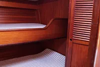 Wooden interior of 1989 Scandinavian Cruiser Eagle with bunk beds and storage.