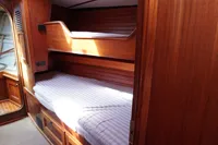 Cozy wooden bunk beds inside a 1989 Scandinavian Cruiser Eagle yacht cabin.