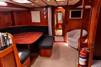 Interior of 1989 Scandinavian Cruiser Eagle with wooden furnishings and cozy seating area.