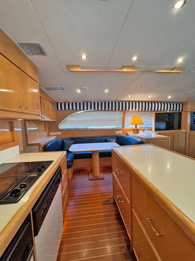  Yacht Photos Pics Interior of a 1999 Bertram 60 Convertible yacht with modern kitchen and dining area.