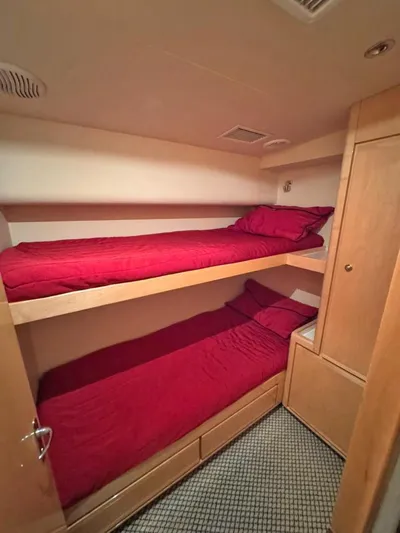 Yacht Photos Pics Bunk beds with red bedding in a 1999 Bertram 60 Convertible yacht cabin.
