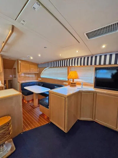 Yacht Photos Pics Interior of a 1999 Bertram 60 Convertible yacht with cozy seating and modern amenities.