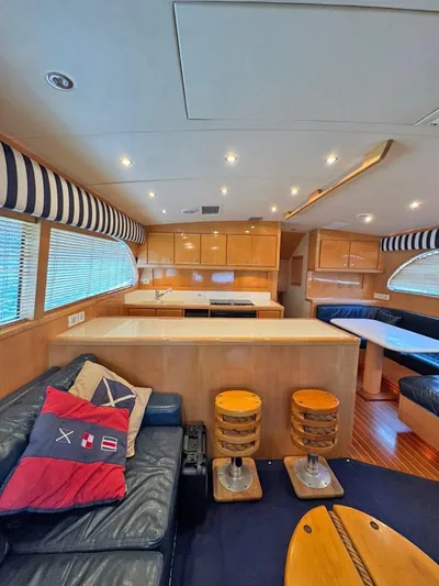  Yacht Photos Pics Interior of a 1999 Bertram 60 Convertible yacht with modern furnishings and nautical decor.