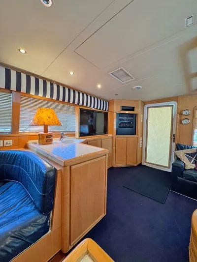 Yacht Photos Pics Interior of a 1999 Bertram 60 Convertible yacht with cozy seating and modern amenities.