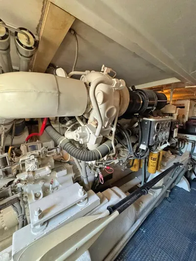  Yacht Photos Pics Engine room of a 1999 Bertram 60 Convertible yacht, showcasing mechanical components.