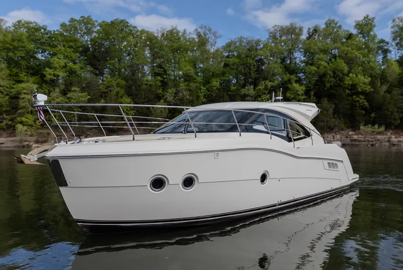 Aflecktion III Yacht Photos Pics 2014 Carver C37 yacht on calm water with lush green forest background.