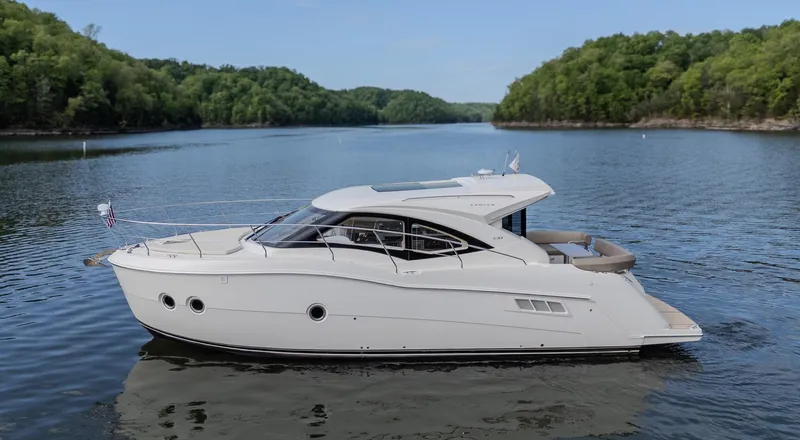 Aflecktion III Yacht Photos Pics 2014 Carver C37 yacht cruising on a serene lake surrounded by lush greenery.