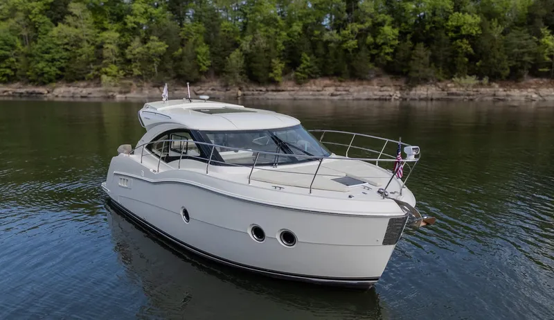 Aflecktion III Yacht Photos Pics 2014 Carver C37 yacht cruising on a serene lake with forested shoreline.