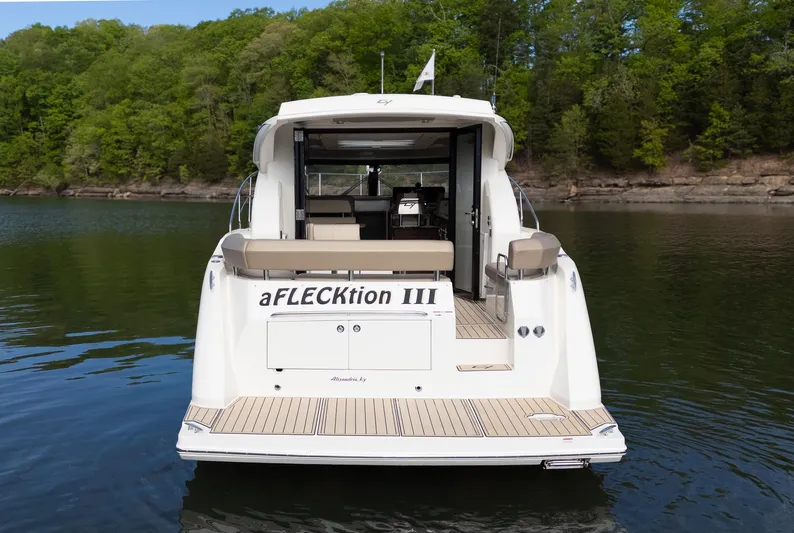 Aflecktion III Yacht Photos Pics 2014 Carver C37 yacht on a serene lake, surrounded by lush green trees.