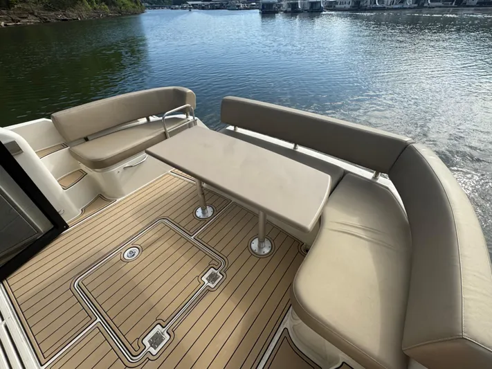 Aflecktion III Yacht Photos Pics Spacious deck of 2014 Carver C37 yacht with seating and table by the water.