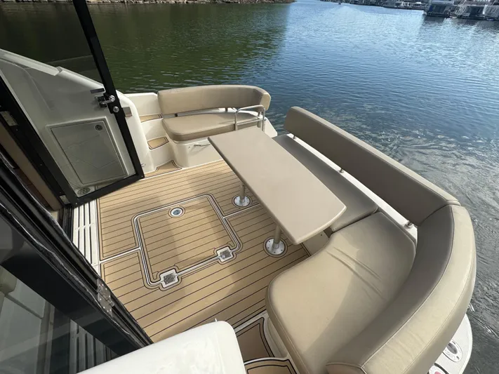 Aflecktion III Yacht Photos Pics 2014 Carver C37 yacht deck with seating and table, overlooking calm water.