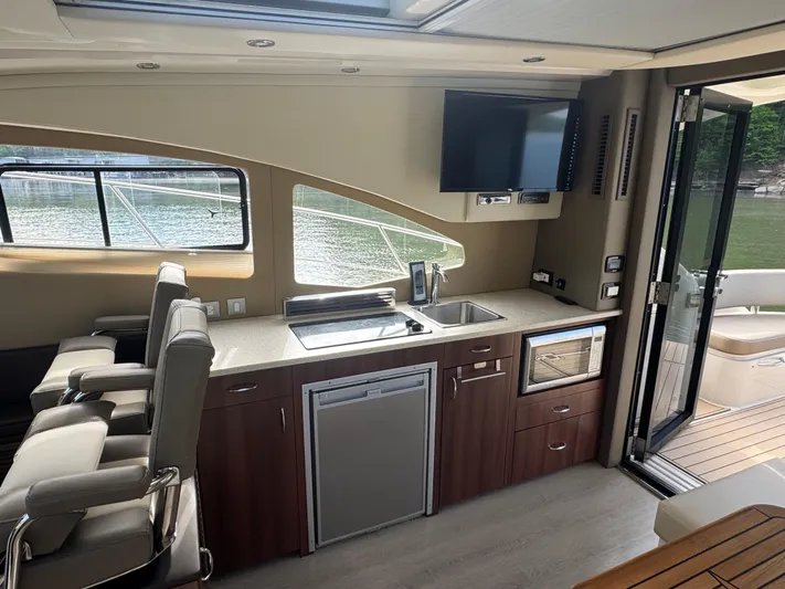 Aflecktion III Yacht Photos Pics Interior of 2014 Carver C37 yacht with kitchenette, seating, and outdoor view.
