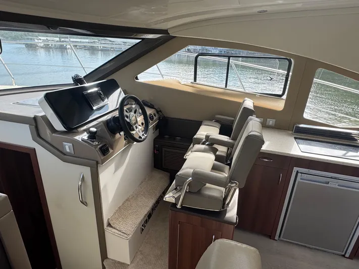 Aflecktion III Yacht Photos Pics Interior of 2014 Carver C37 yacht with helm, seating, and kitchenette.