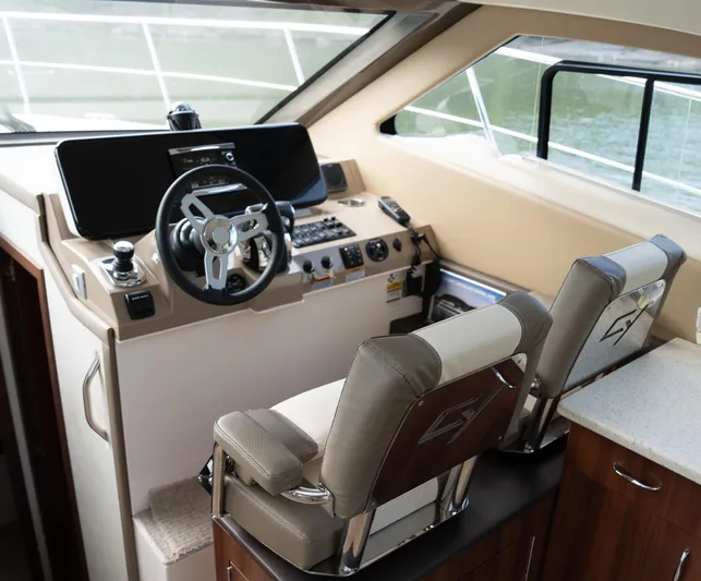 Aflecktion III Yacht Photos Pics Interior helm of 2014 Carver C37 yacht with modern controls and seating.