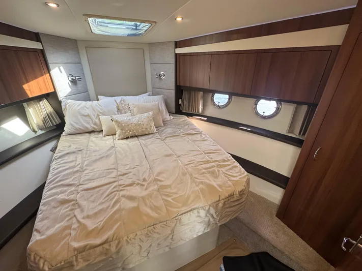 Aflecktion III Yacht Photos Pics Luxurious bedroom interior of 2014 Carver C37 yacht with elegant bedding and wood accents.
