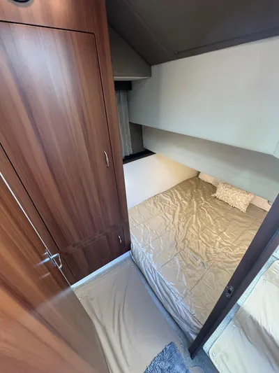 Aflecktion III Yacht Photos Pics 2014 Carver C37 cabin interior with cozy bed and wooden cabinetry.