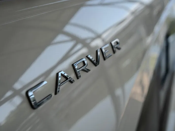 Aflecktion III Yacht Photos Pics Close-up of 2014 Carver C37 logo on a sleek, reflective surface.