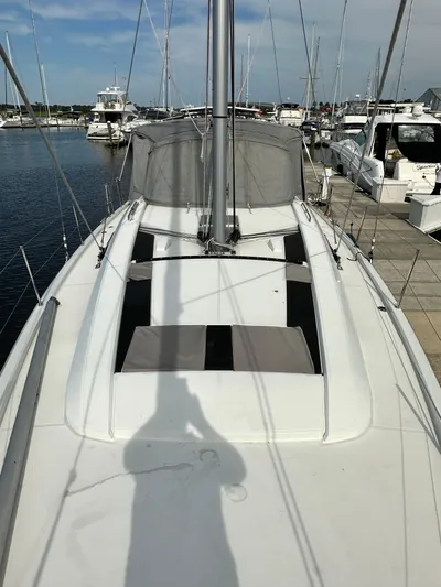 Chasing Summer Yacht Photos Pics 2022 Beneteau Oceanis 46.1 sailboat docked at marina, view of deck and mast.