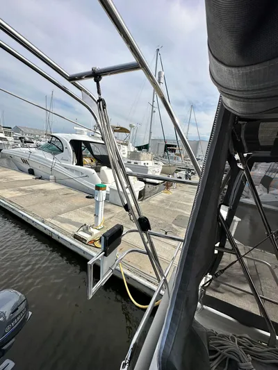 Chasing Summer Yacht Photos Pics Beneteau Oceanis 46.1 yacht docked at marina, 2022 model, with surrounding boats and clear sky.