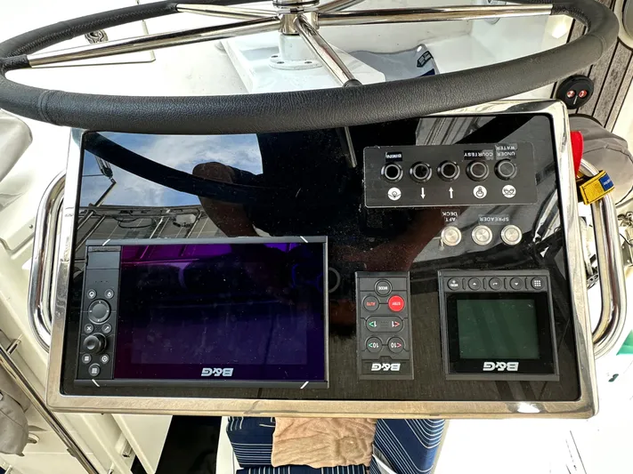 Chasing Summer Yacht Photos Pics Steering console of 2022 Beneteau Oceanis 46.1 yacht with navigation controls.