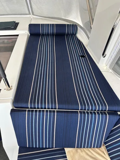Chasing Summer Yacht Photos Pics Blue striped seating on 2022 Beneteau Oceanis 46.1 yacht deck.