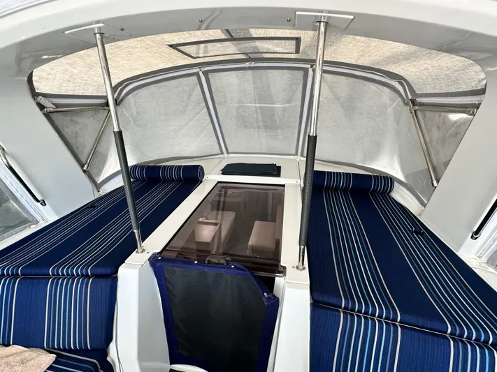 Chasing Summer Yacht Photos Pics Interior view of 2022 Beneteau Oceanis 46.1 yacht with striped blue seating.