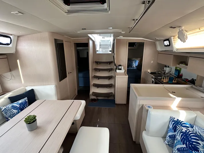 Chasing Summer Yacht Photos Pics Luxurious interior of 2022 Beneteau Oceanis 46.1 yacht with modern furnishings and elegant design.