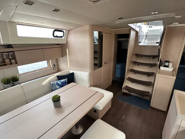 Chasing Summer Yacht Photos Pics Luxurious interior of 2022 Beneteau Oceanis 46.1 yacht with modern furnishings and elegant design.